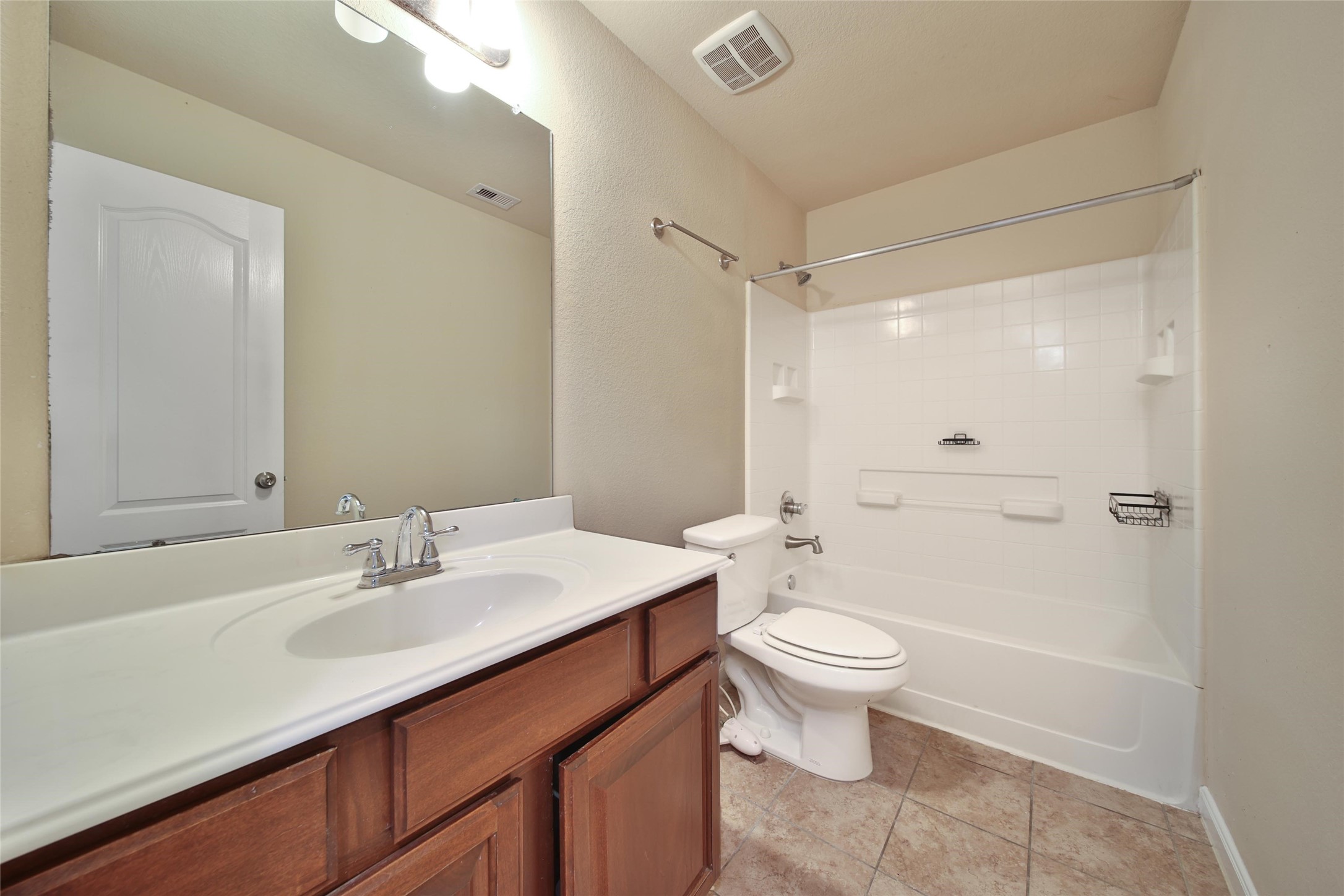 19134 Painted Boulevard Porter, TX 77365 - Photo 28 of 34 a bathroom with a sink a toilet a mirror and shower