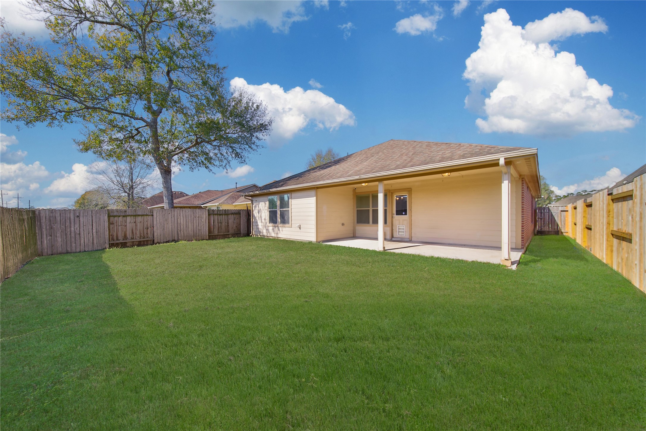 19134 Painted Boulevard Porter, TX 77365 - Photo 6 of 34 a view of a backyard with plants and large trees