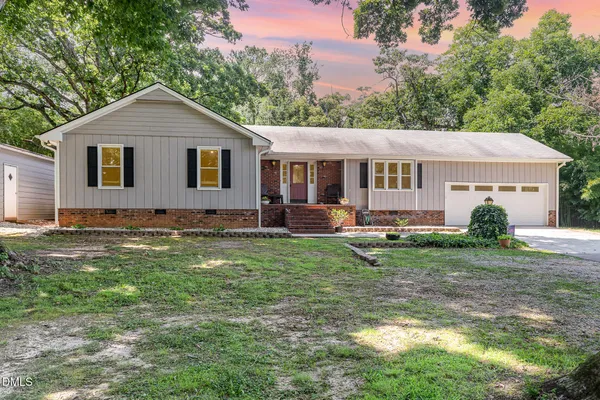 a front view of house with yard and green space