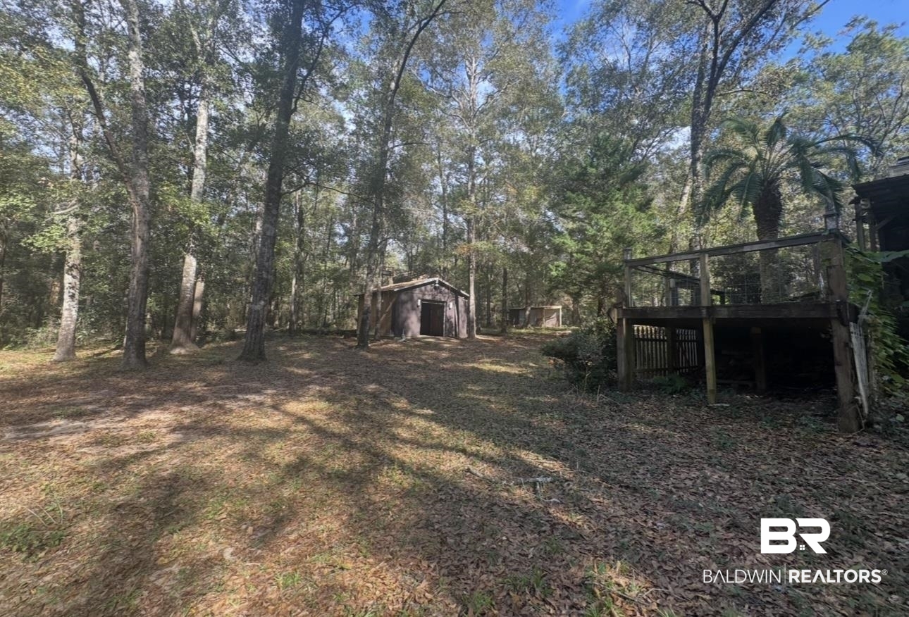 23341 County Road 49 Silverhill, AL 36576 - Photo 19 of 23 View of yard with an outbuilding and a wooden deck