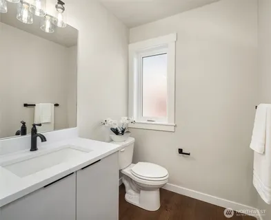 a bathroom with a sink a toilet and mirror