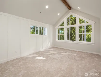 an empty room with large windows