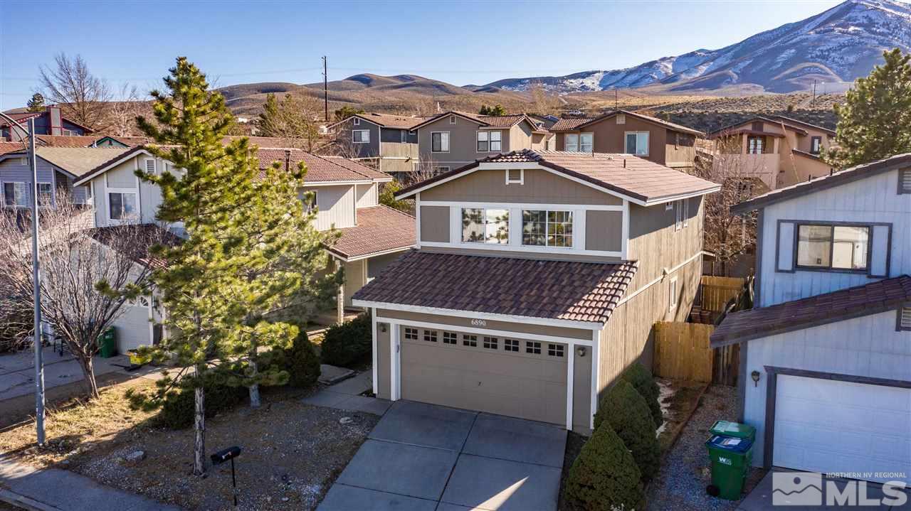 6890 Forsythia Way Reno, NV 89506 - Photo 1 of 17 a front view of a house with a yard