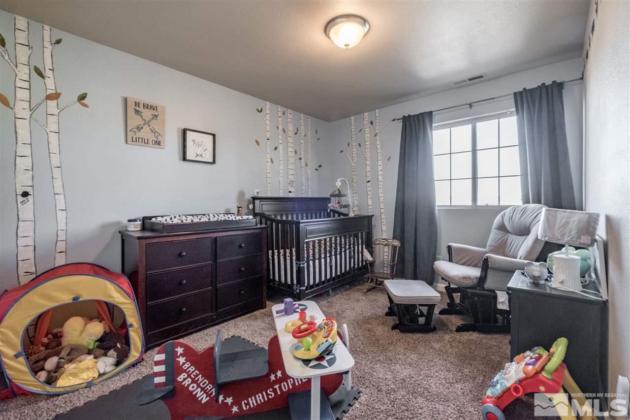 6890 Forsythia Way Reno, NV 89506 - Photo 11 of 17 a bedroom with furniture and a window