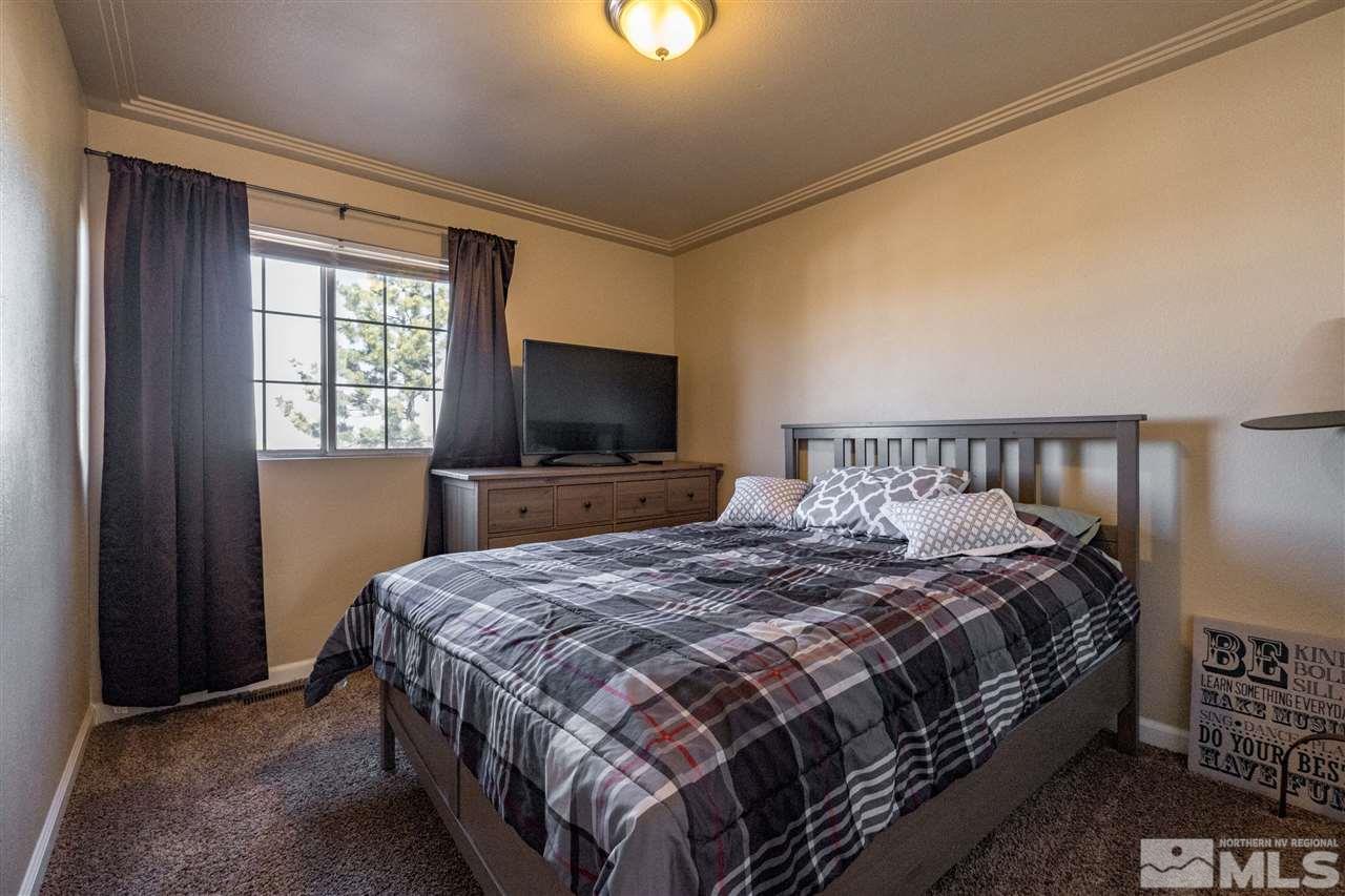 6890 Forsythia Way Reno, NV 89506 - Photo 12 of 17 a bedroom with a bed and a flat screen tv