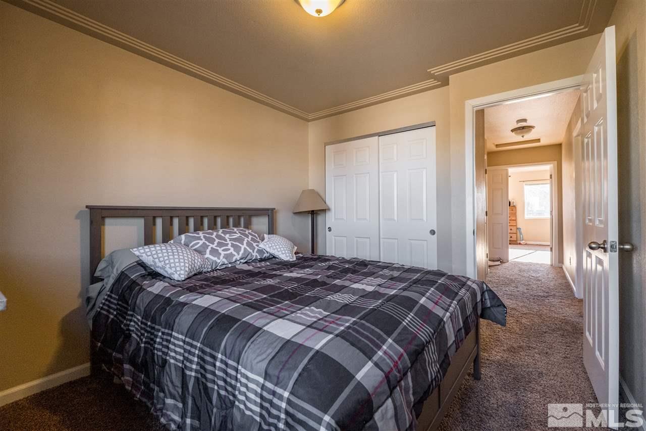 6890 Forsythia Way Reno, NV 89506 - Photo 13 of 17 a bedroom with a large bed and a closet
