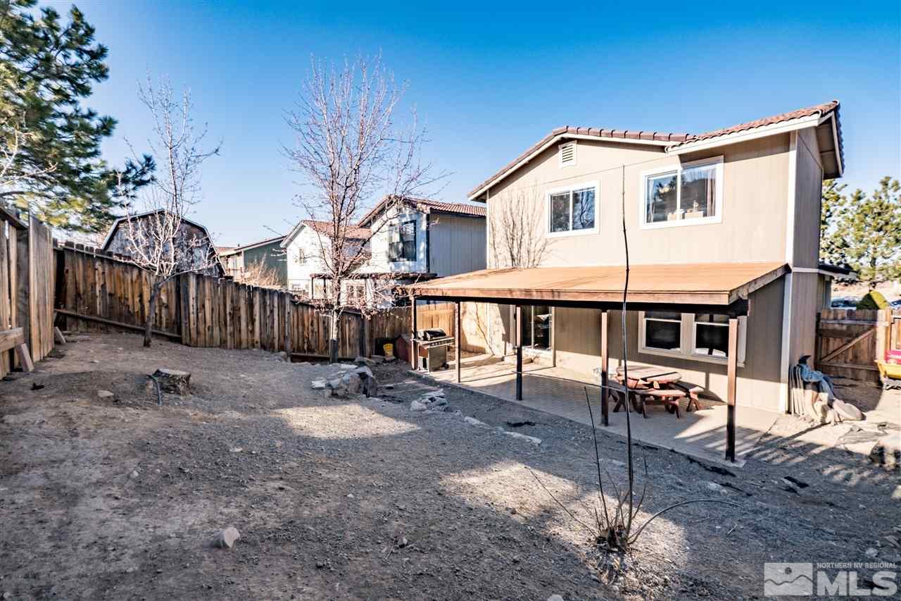 6890 Forsythia Way Reno, NV 89506 - Photo 16 of 17 a backyard of a house with barbeque oven table and chairs