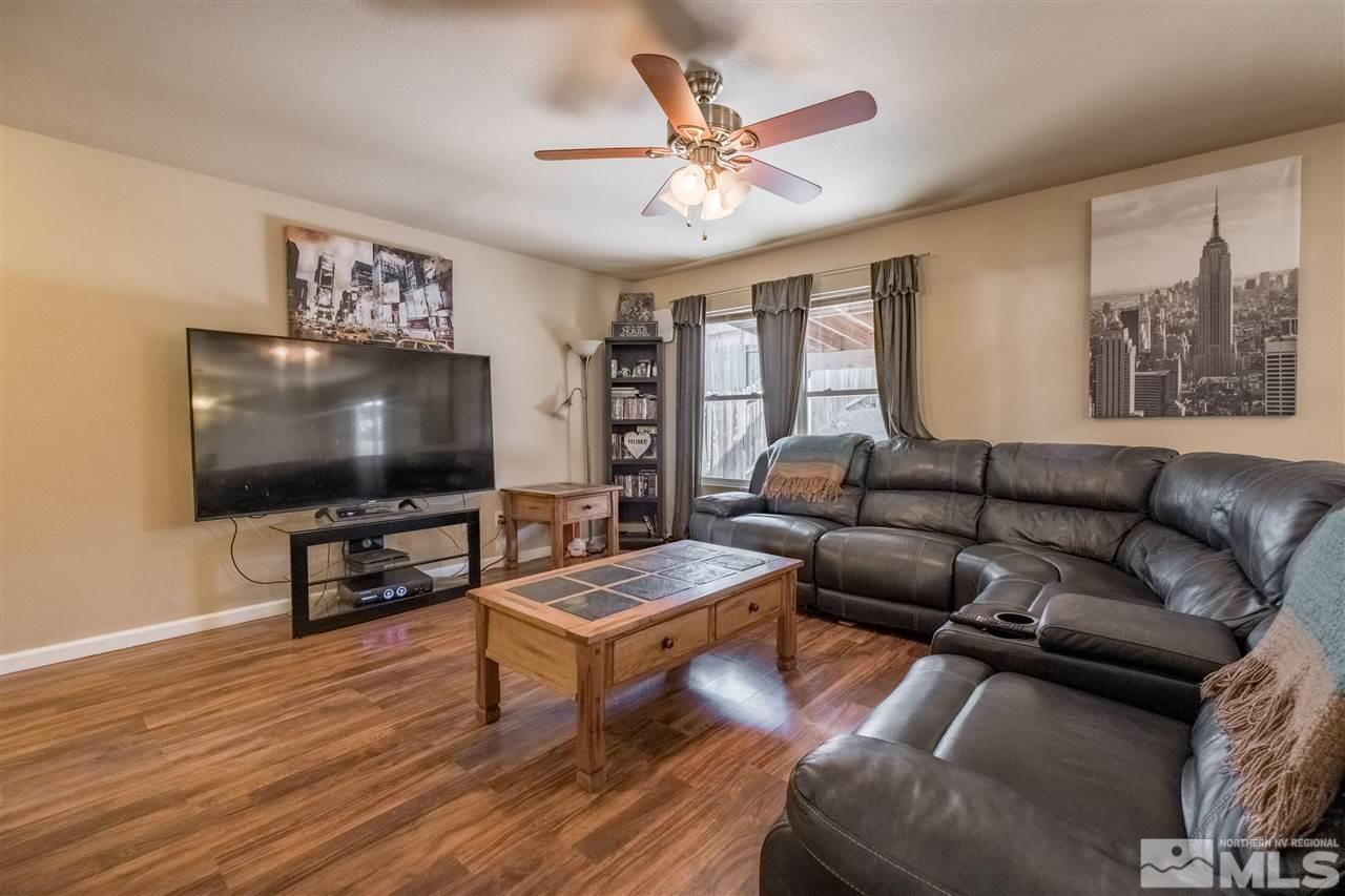 6890 Forsythia Way Reno, NV 89506 - Photo 4 of 17 a living room with furniture and a flat screen tv