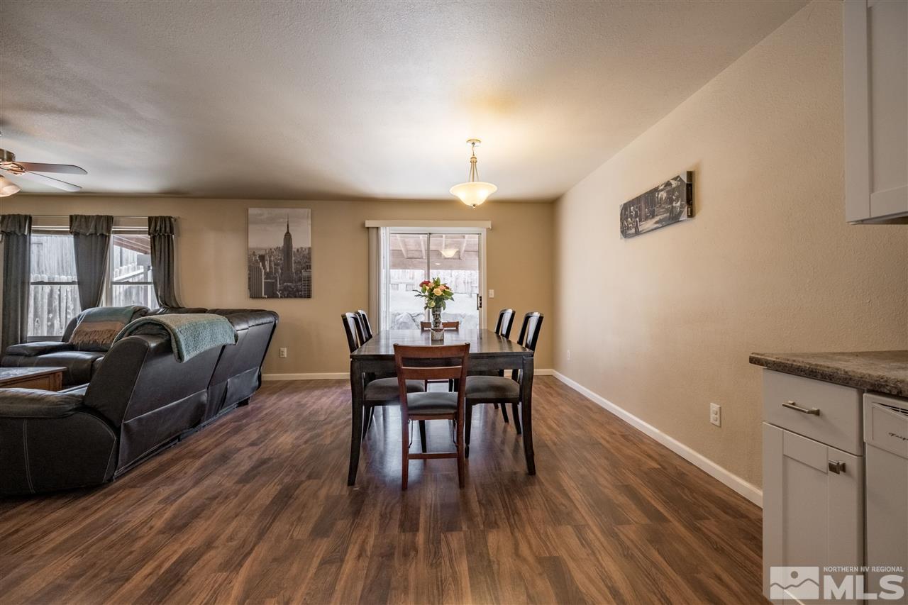 6890 Forsythia Way Reno, NV 89506 - Photo 5 of 17 a living room with furniture a dining table and a wooden floor
