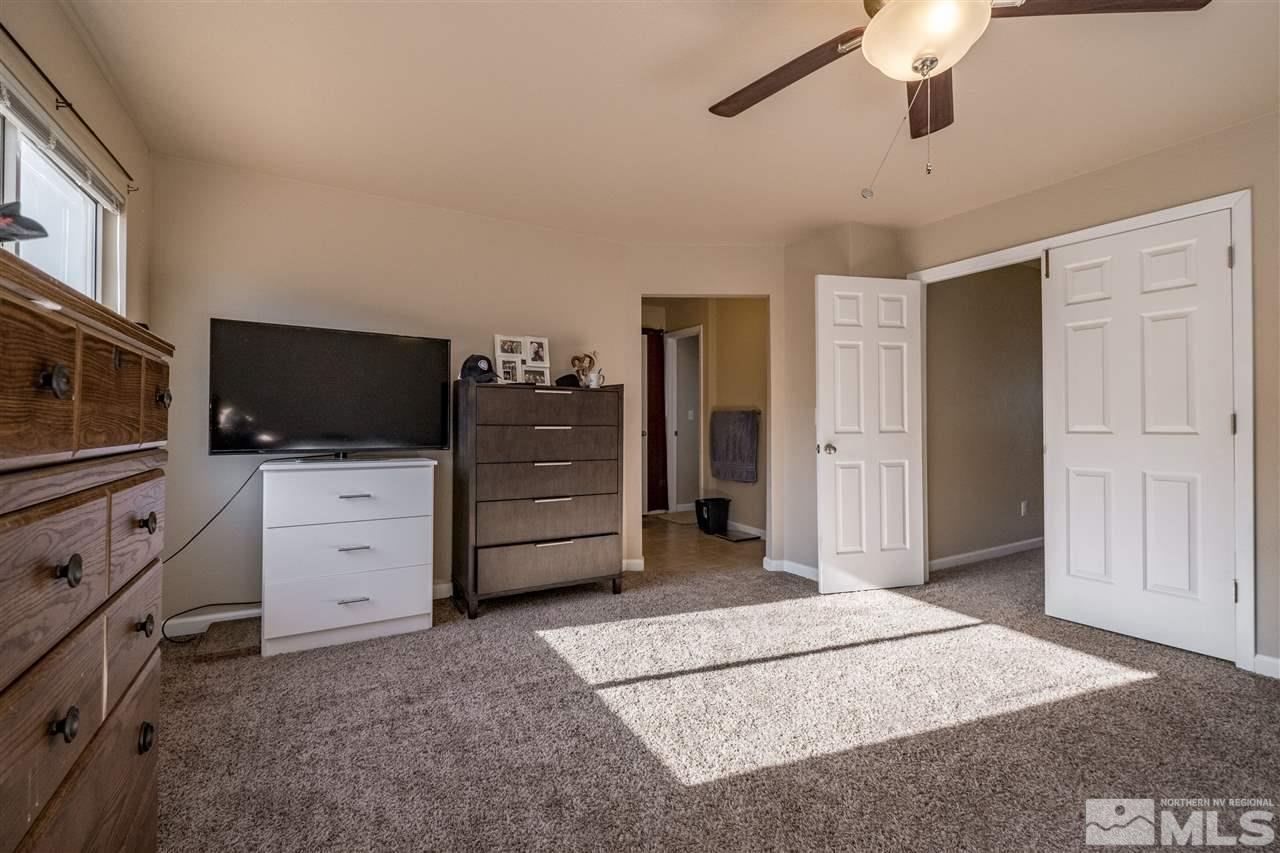 6890 Forsythia Way Reno, NV 89506 - Photo 8 of 17 a view of a bedroom with cabinet flat screen tv and cabinet