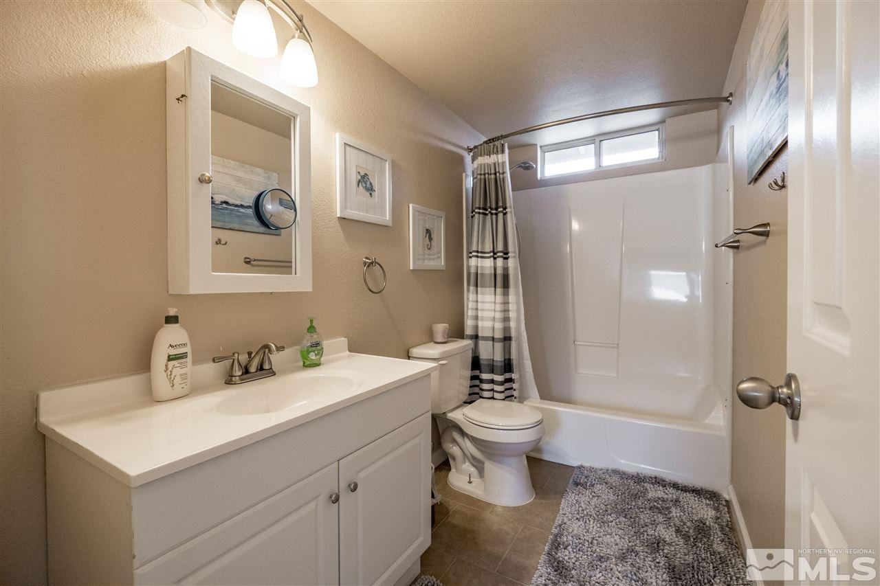 6890 Forsythia Way Reno, NV 89506 - Photo 10 of 17 a bathroom with a sink toilet and shower