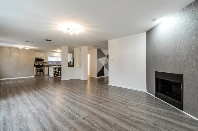 a view of an empty room and wooden floor