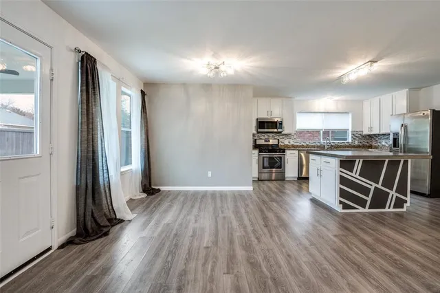 a kitchen with stainless steel appliances a stove top oven and cabinets