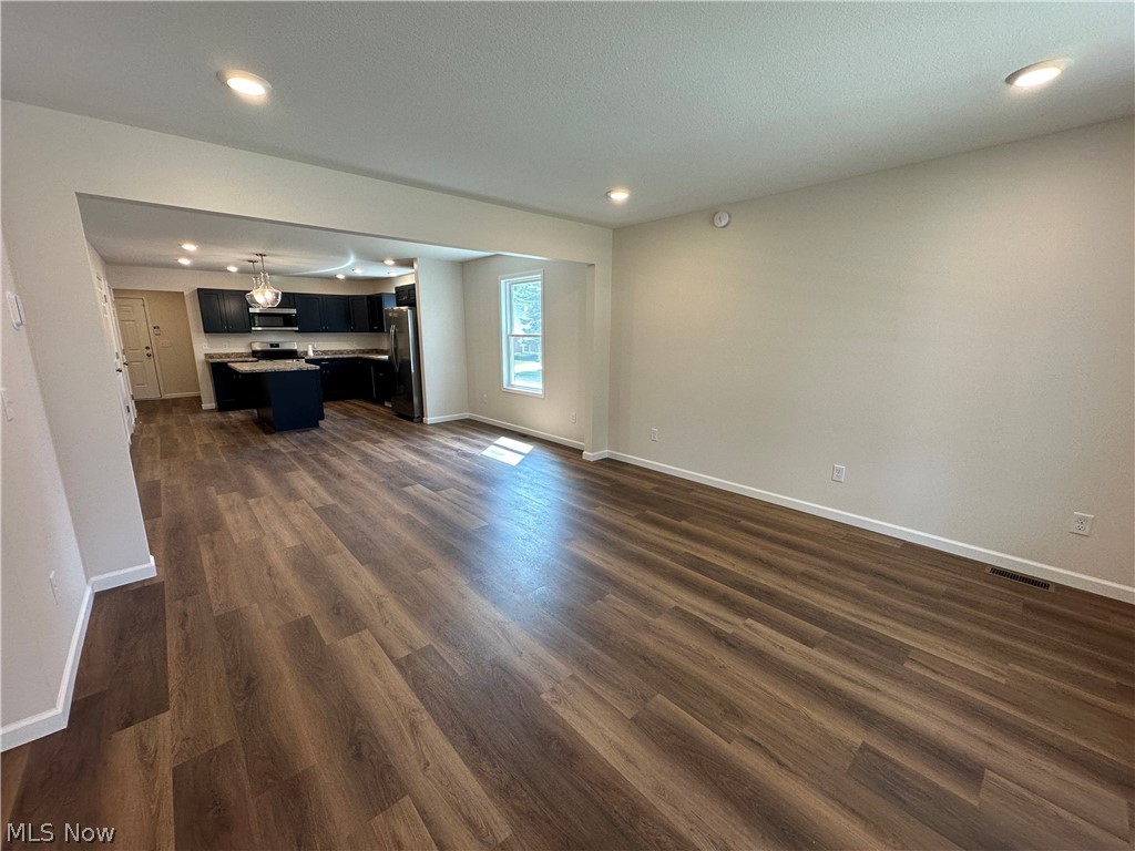 78 Prospect Street Struthers, OH 44471 - Photo 5 of 17 Open-concept living space featuring LTV flooring and recessed lighting