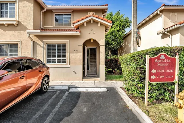 a front view of a house with parking area