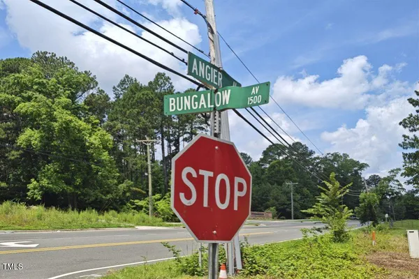an aerial view of residential house with outdoor space and trees all around