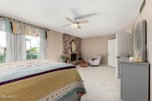 a bedroom with a bed and large windows