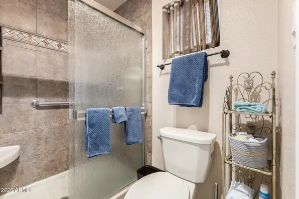 a white toilet sitting next to a bathroom sink