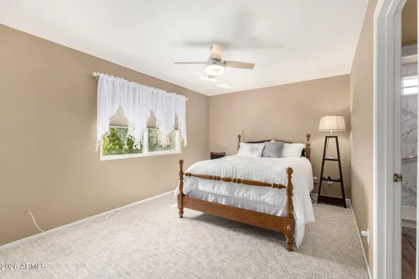 a spacious bedroom with a bed and a window