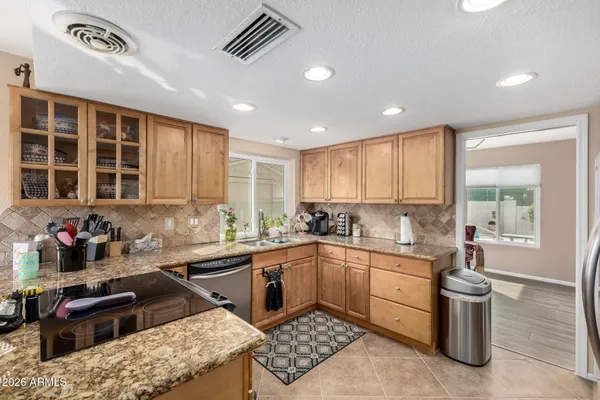 a kitchen with a sink stove top oven and cabinets