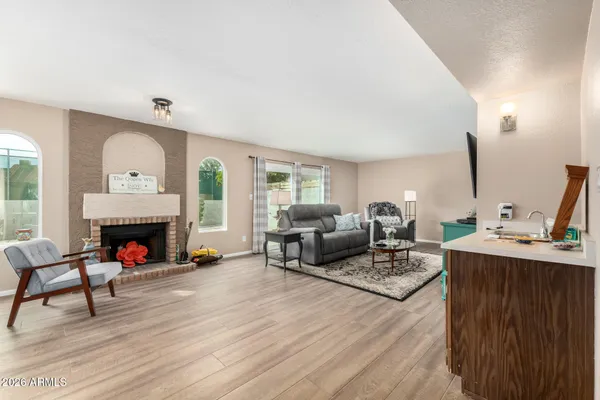 a living room with furniture fireplace and window