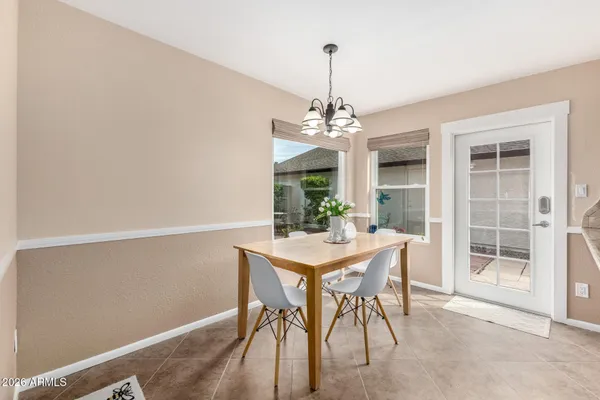 a view of a dining room with a table and chairs