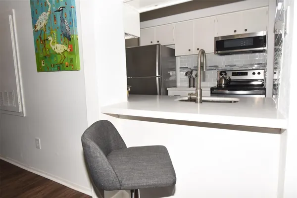 a kitchen with stainless steel appliances a refrigerator and a sink
