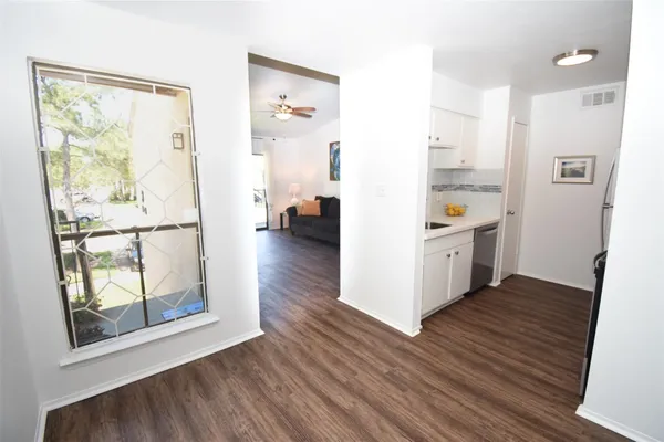 a view of kitchen with furniture and wooden floor