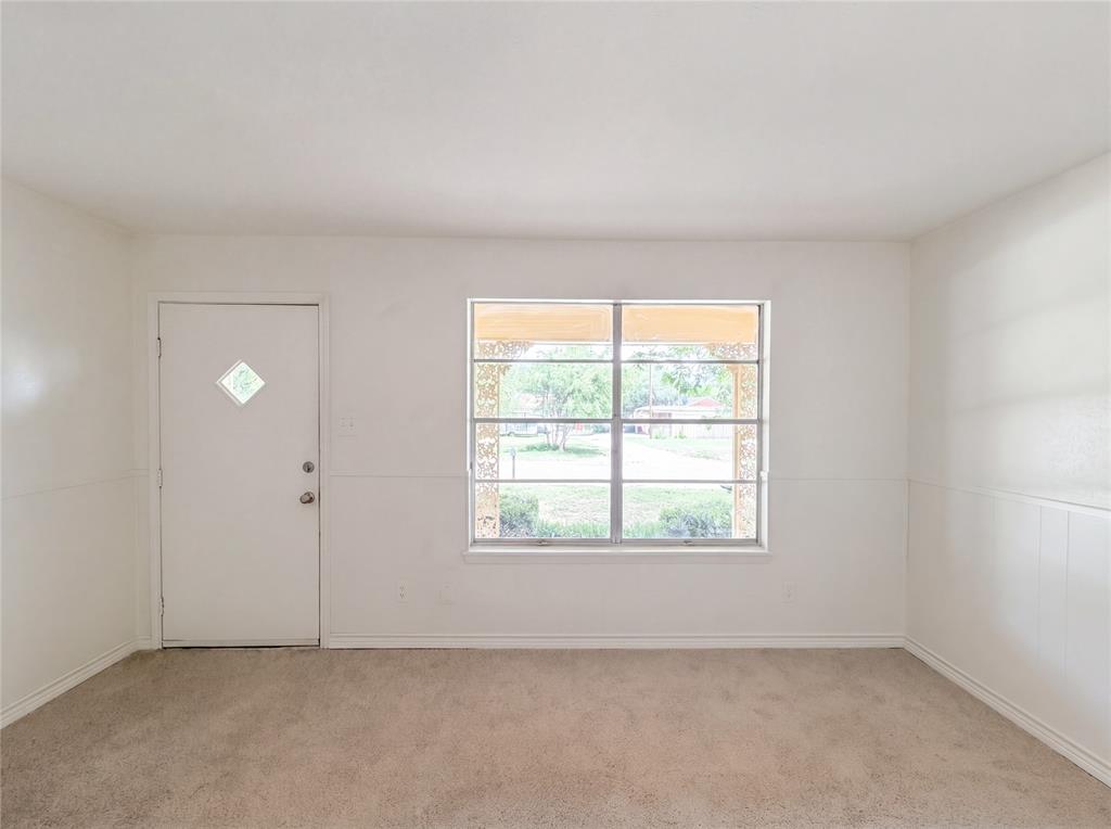205 West Decatur Street Chico, TX 76431 - Photo 3 of 19 an empty room with windows