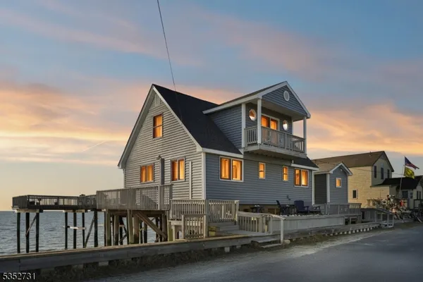 a front view of a house with yard and balcony