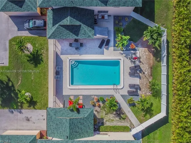 an aerial view of a house with a yard