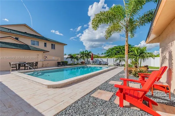 a swimming pool with outdoor seating and yard