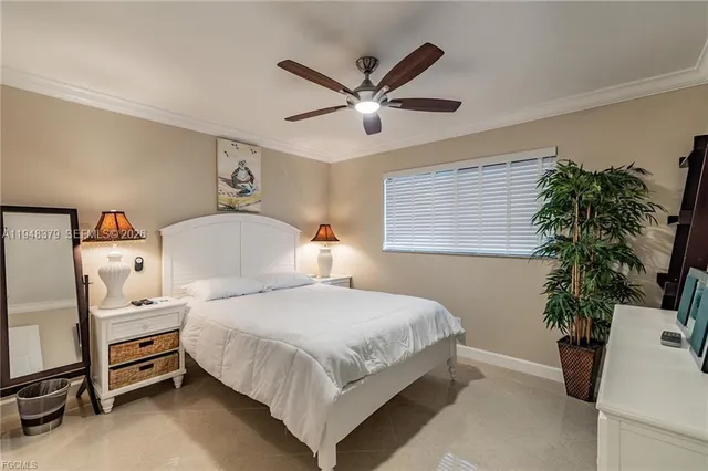 a bedroom with a bed and a potted plant