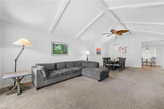 a living room with furniture and a lamp