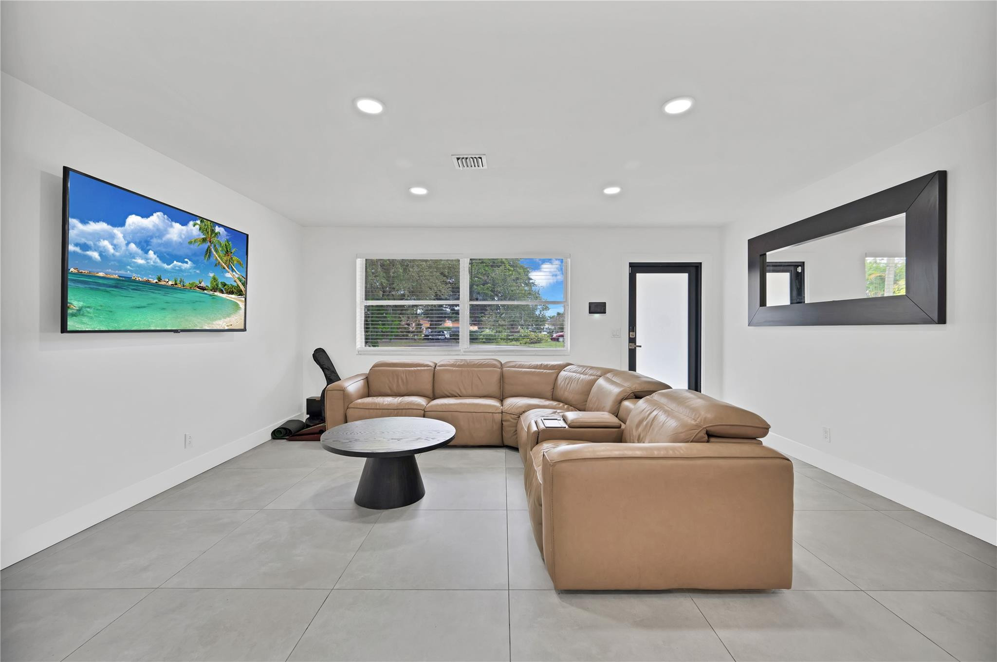 300 Southwest 65th Way Pembroke Pines, FL 33023 - Photo 11 of 35 a living room with furniture and a flat screen tv