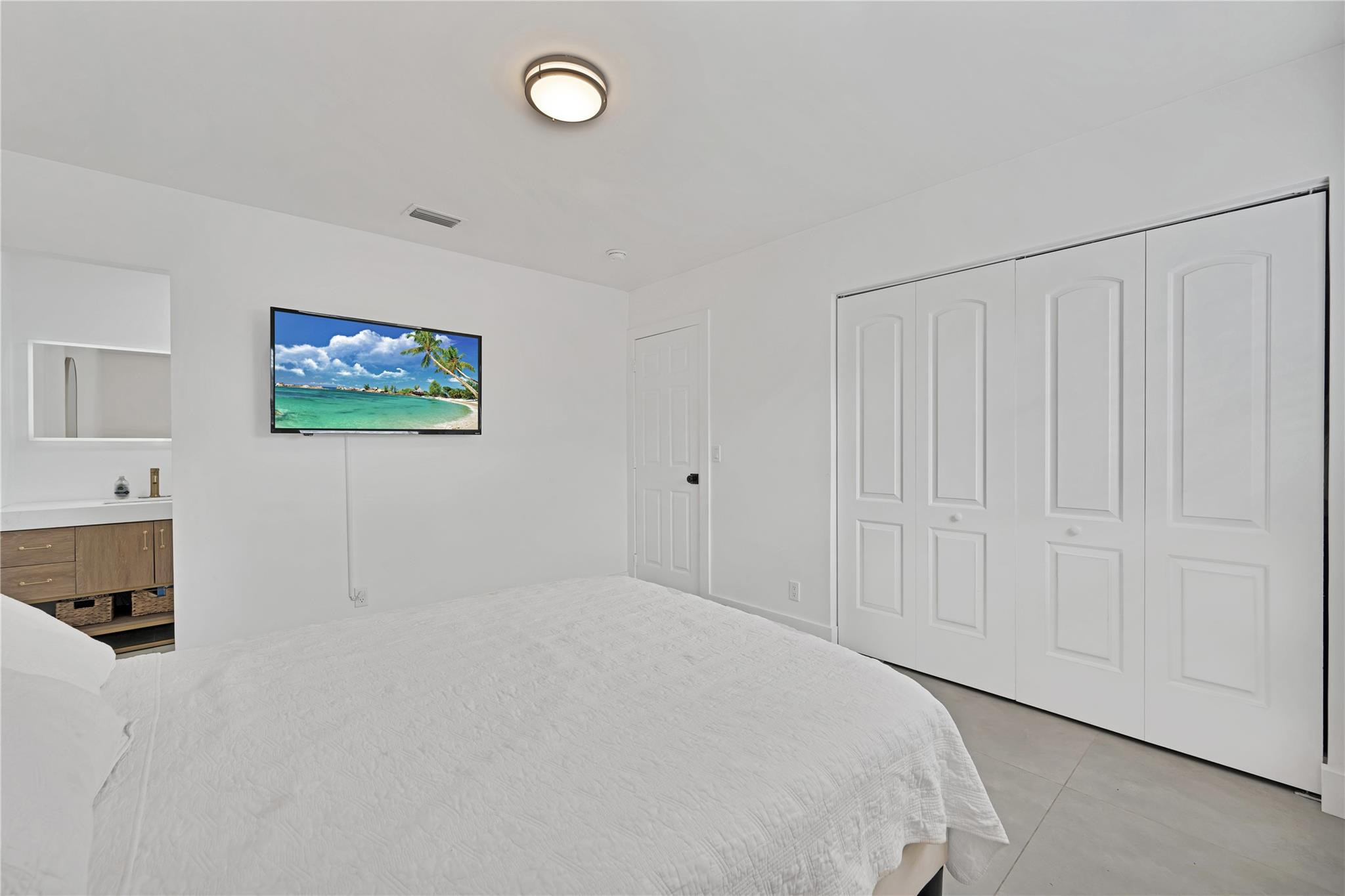 300 Southwest 65th Way Pembroke Pines, FL 33023 - Photo 17 of 35 a bedroom with a bed and a tv
