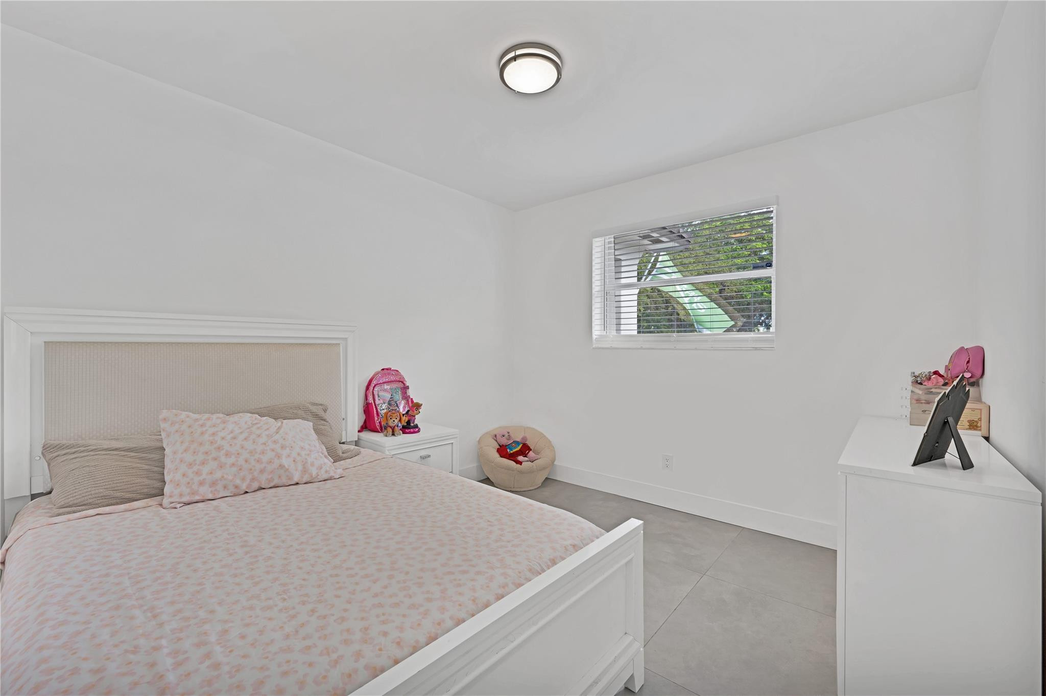 300 Southwest 65th Way Pembroke Pines, FL 33023 - Photo 19 of 35 a bedroom with a bed and a chandelier