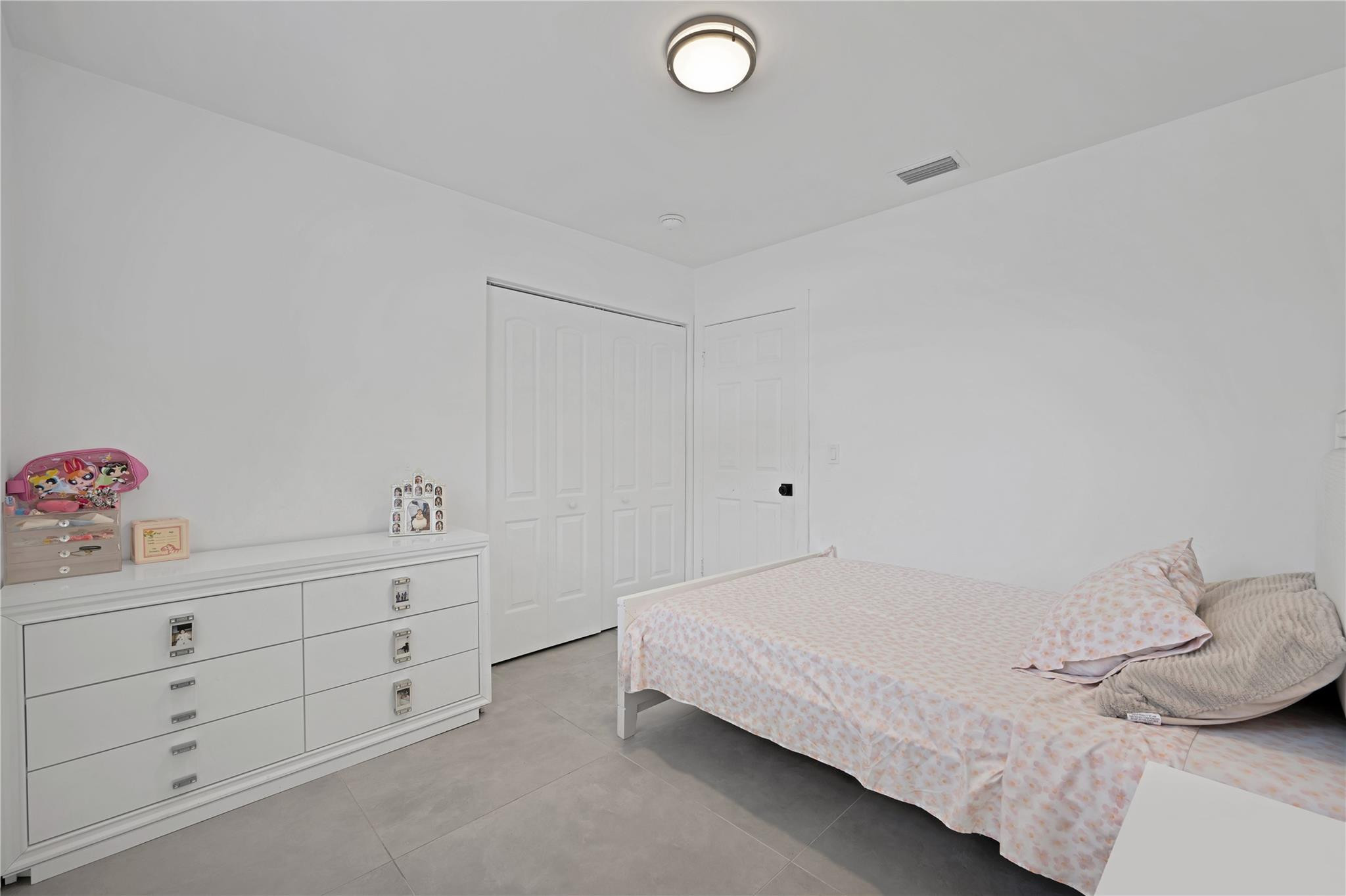 300 Southwest 65th Way Pembroke Pines, FL 33023 - Photo 20 of 35 a bedroom with a bed and a dresser