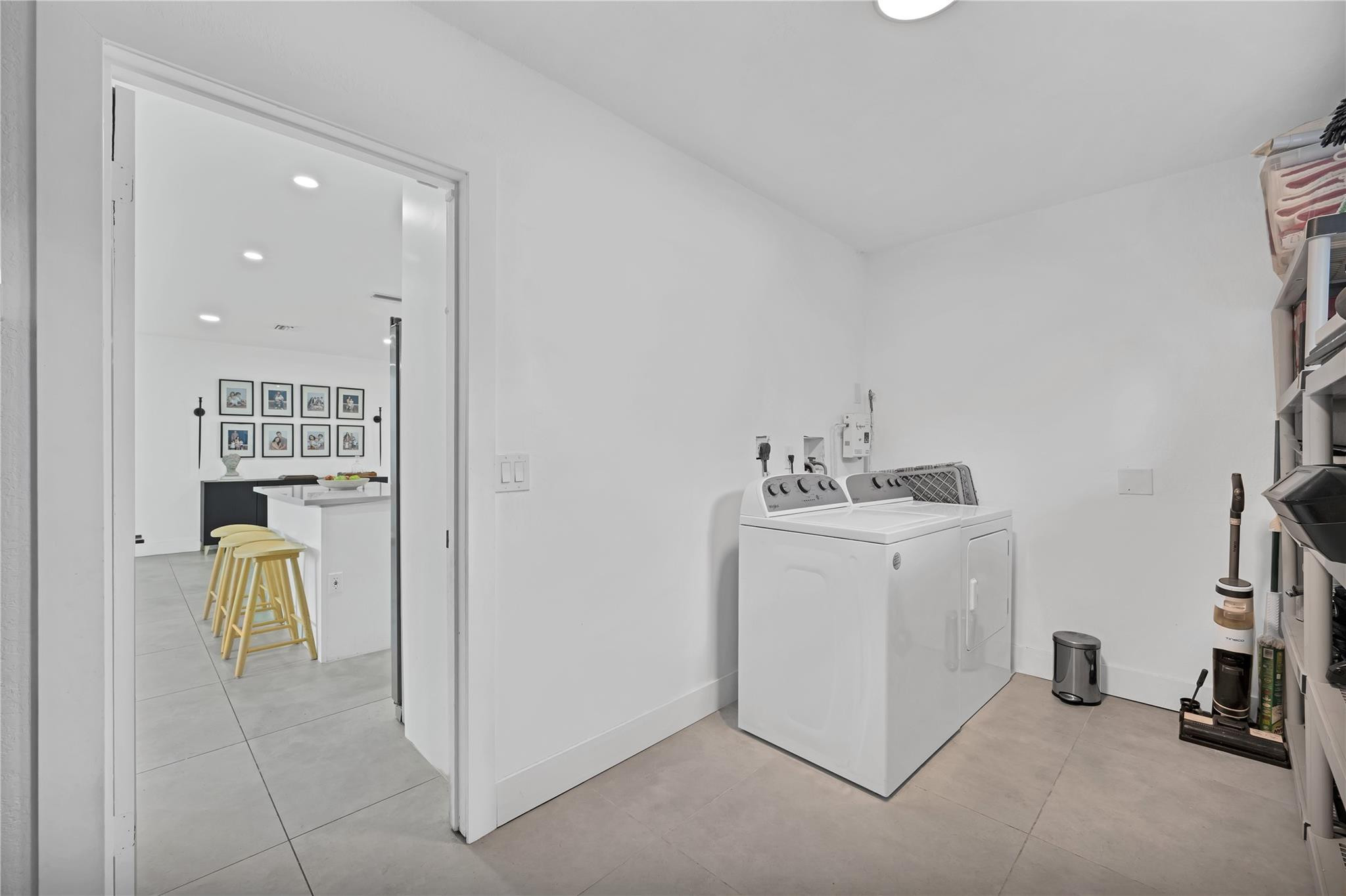 300 Southwest 65th Way Pembroke Pines, FL 33023 - Photo 24 of 35 a utility room with cabinets washer and dryer