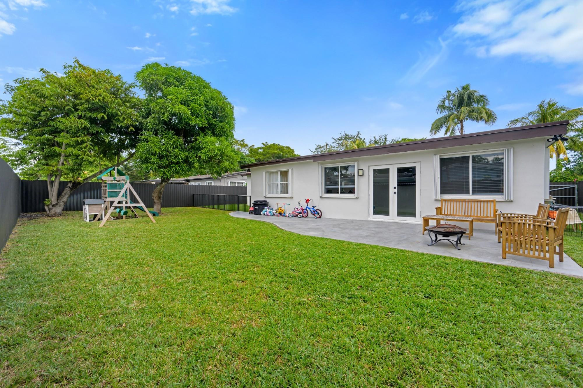 300 Southwest 65th Way Pembroke Pines, FL 33023 - Photo 27 of 35 a front view of a house with patio and garden