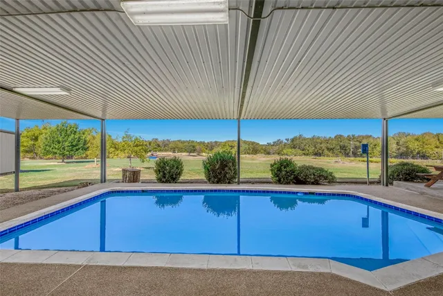 an empty room with windows and ceiling fan