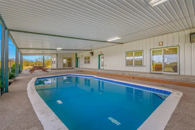 a view of swimming pool with outdoor seating