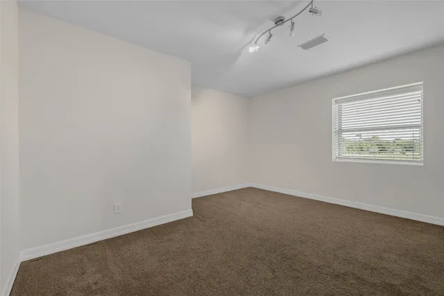 a bathroom with a granite countertop tub a sink and mirror