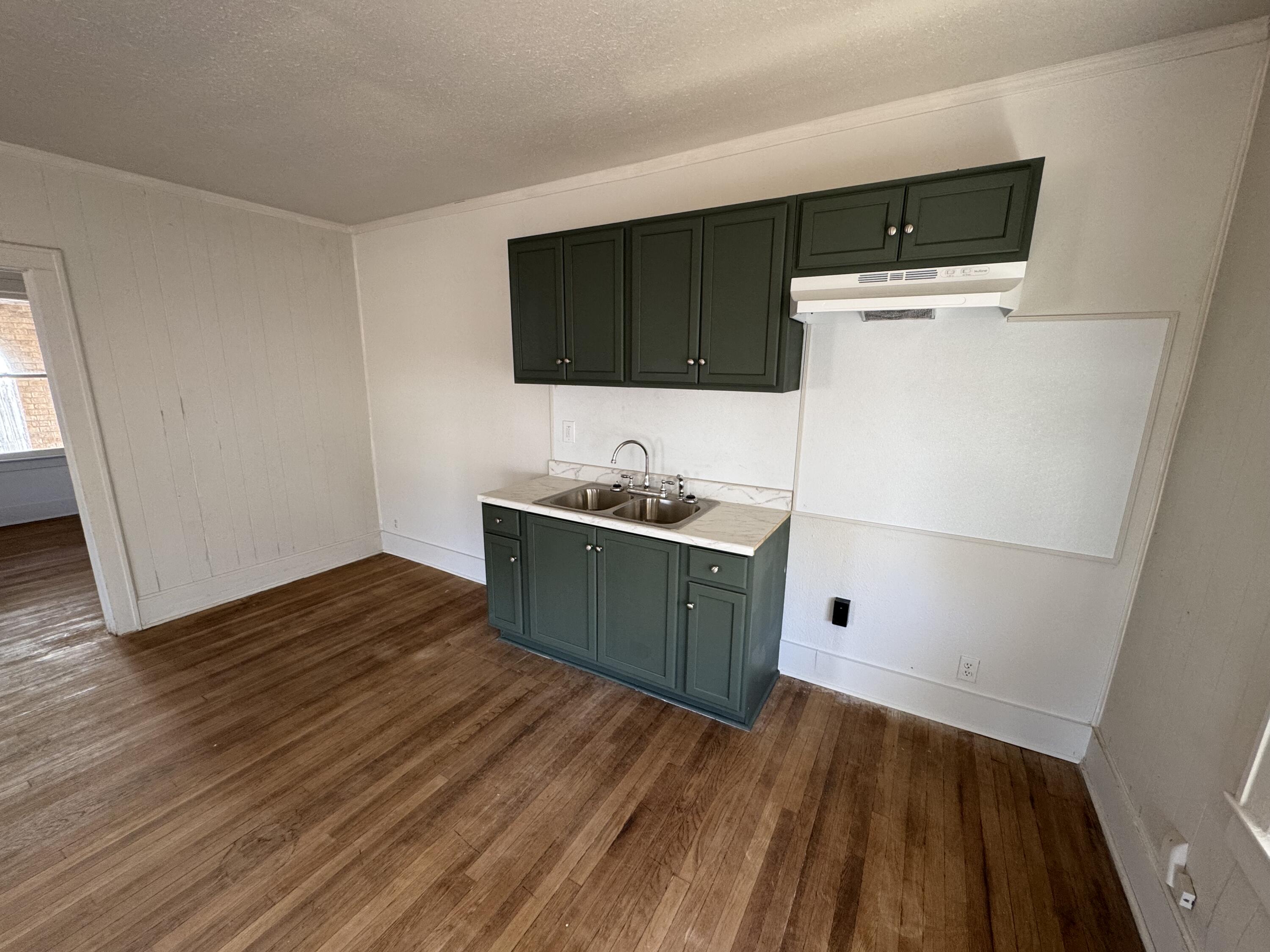 1903 16th Street, Unit A Lubbock, TX 79401 - Photo 5 of 7 a kitchen with a sink and a microwave