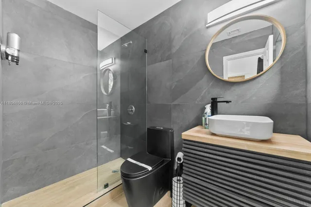 a bathroom with a sink toilet and shower