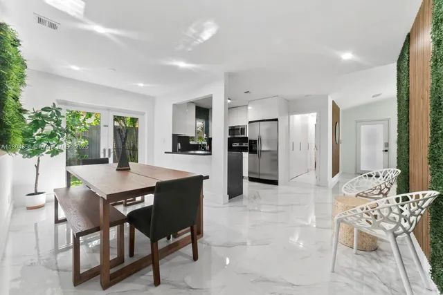 a large kitchen with a table and chairs
