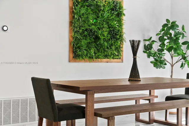 a view of a dining room with furniture and window