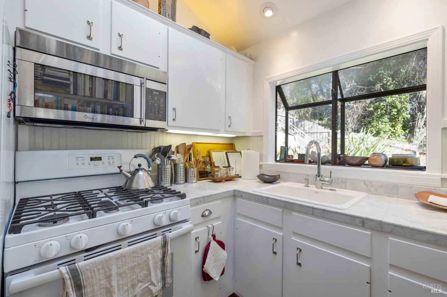 40 Canyon Road San Anselmo, CA 94960 - Photo 37 of 56 Kitchen with marble counters and a garden window looking into the yard