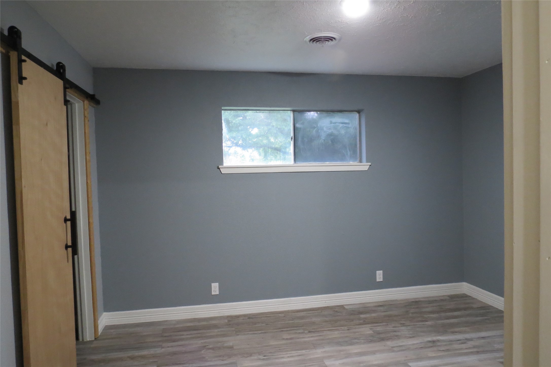 3120 Montgomery Road Huntsville, TX 77340 - Photo 11 of 16 an empty room with wooden floor and closet