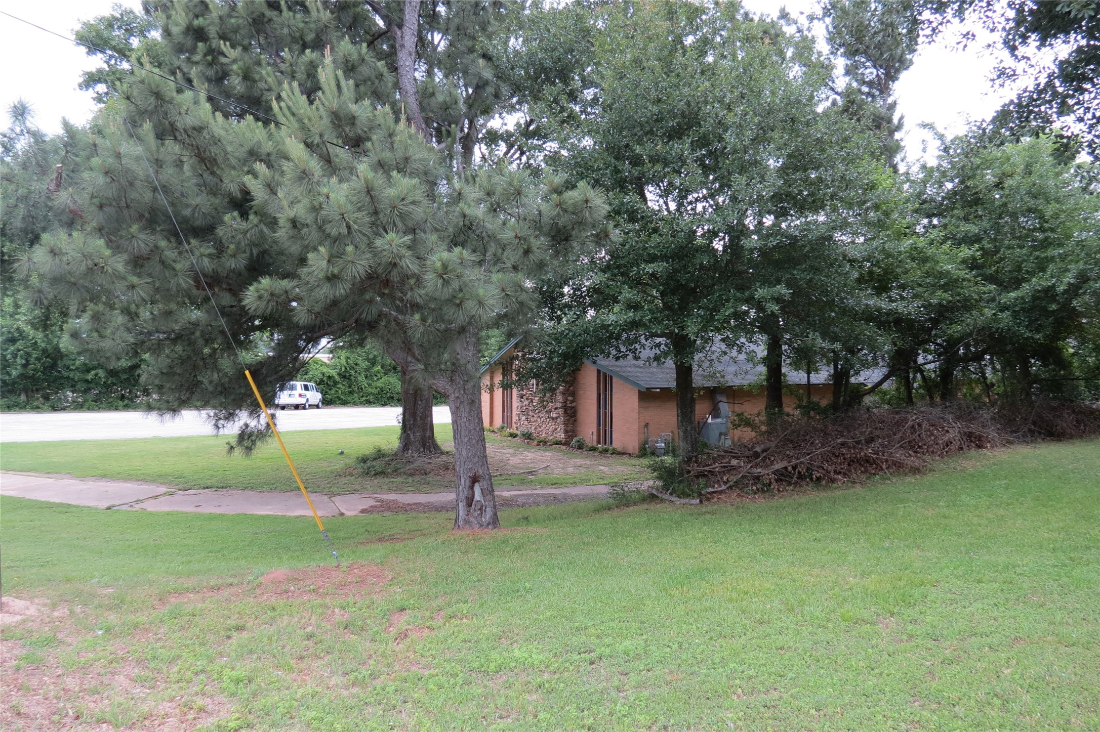 3120 Montgomery Road Huntsville, TX 77340 - Photo 8 of 16 a view of a house with a yard and tree s